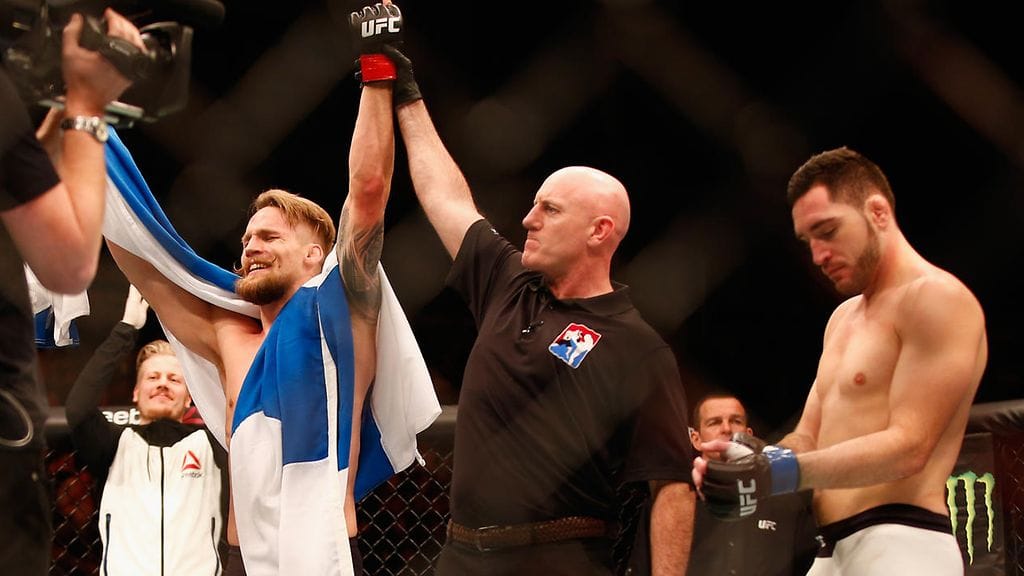 Suomen lippuun kietoutunut Teemu Packalen puhkesi kyyneliin uransa ensimmäisen UFC-voiton jälkeen.