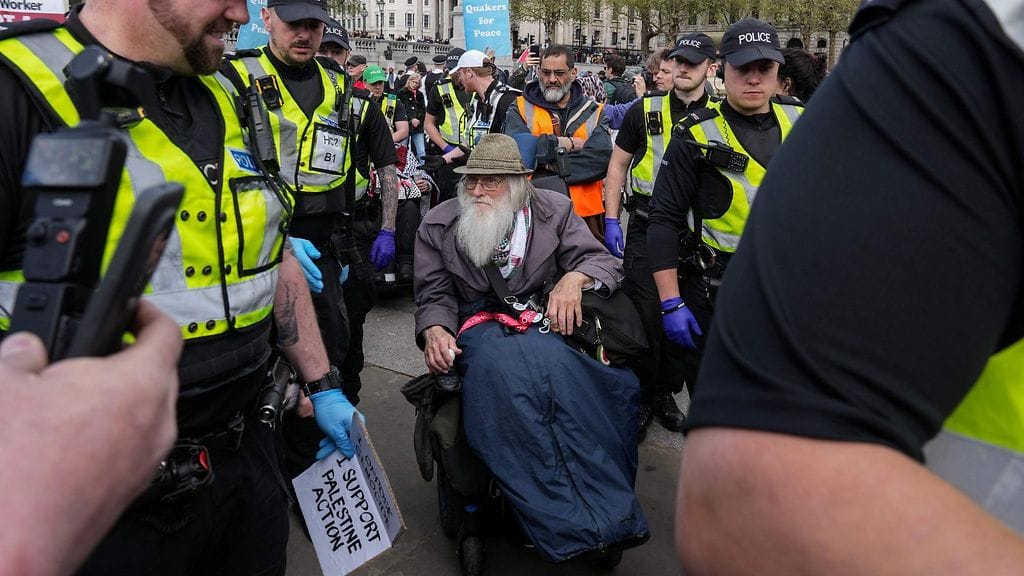 Iäkäs pyörätuolilla kulkeva mies ohjattiin pois mielenosoituksesta poliisivoimin.